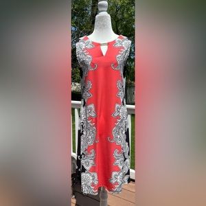Coral, white and black dress with gold neck accent. Size Small. Stretchy.